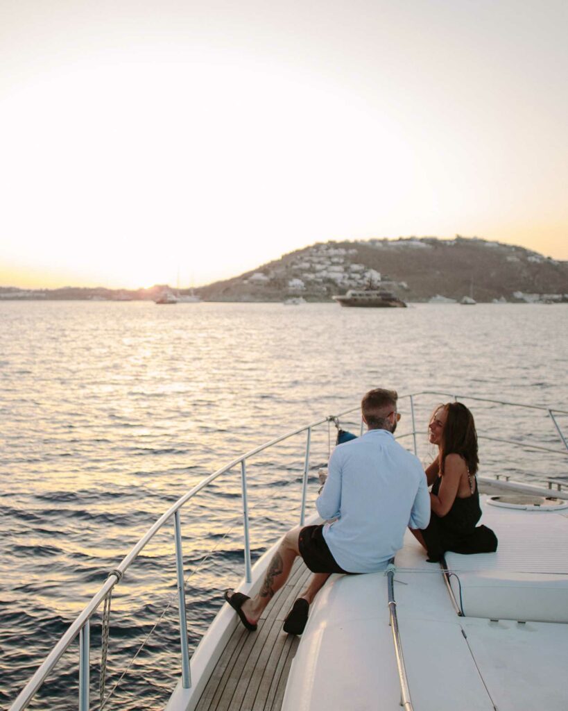 couple enjoying a romantic sunset on a yacht
